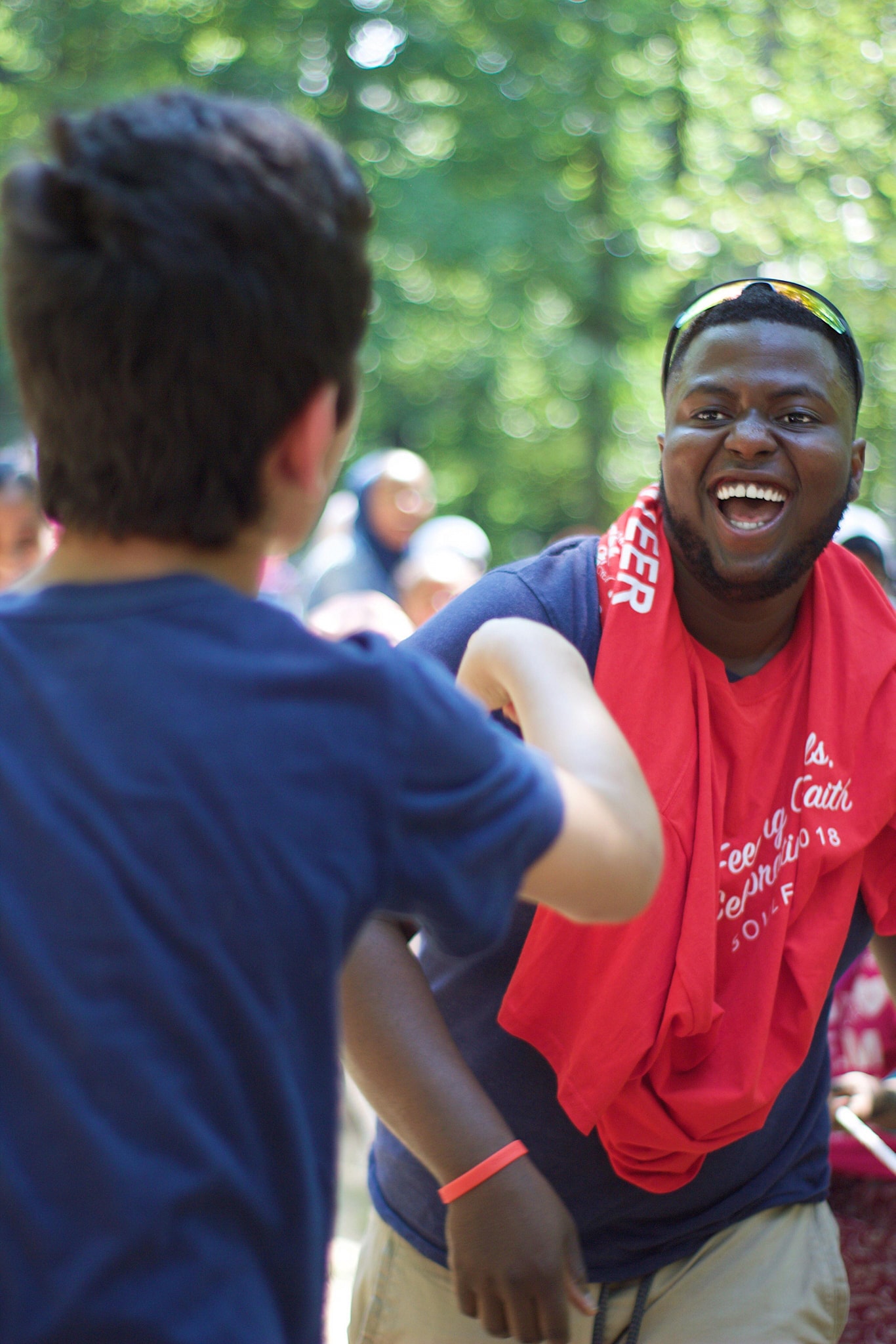 An excited volunteer engaging with a child at an event